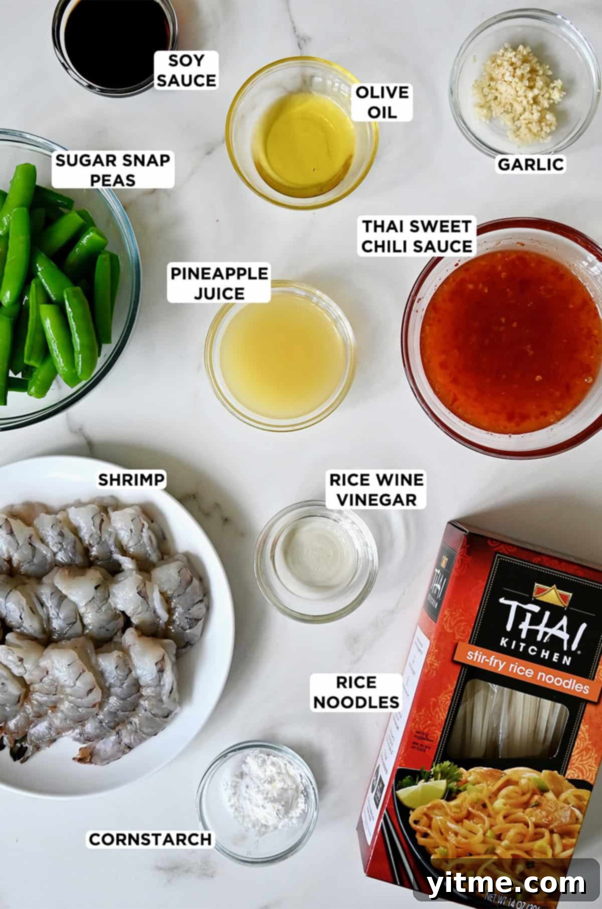 Ingredients for sweet and sour shrimp stir-fry including noodles, shrimp, and sauce ingredients.