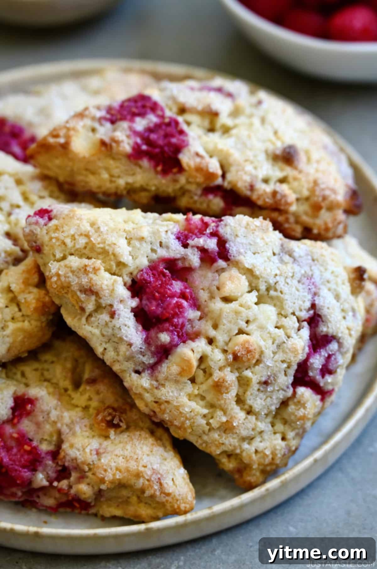Raspberry Bliss Scones 8 Close-up of delicious white chocolate raspberry scones served on a plate.