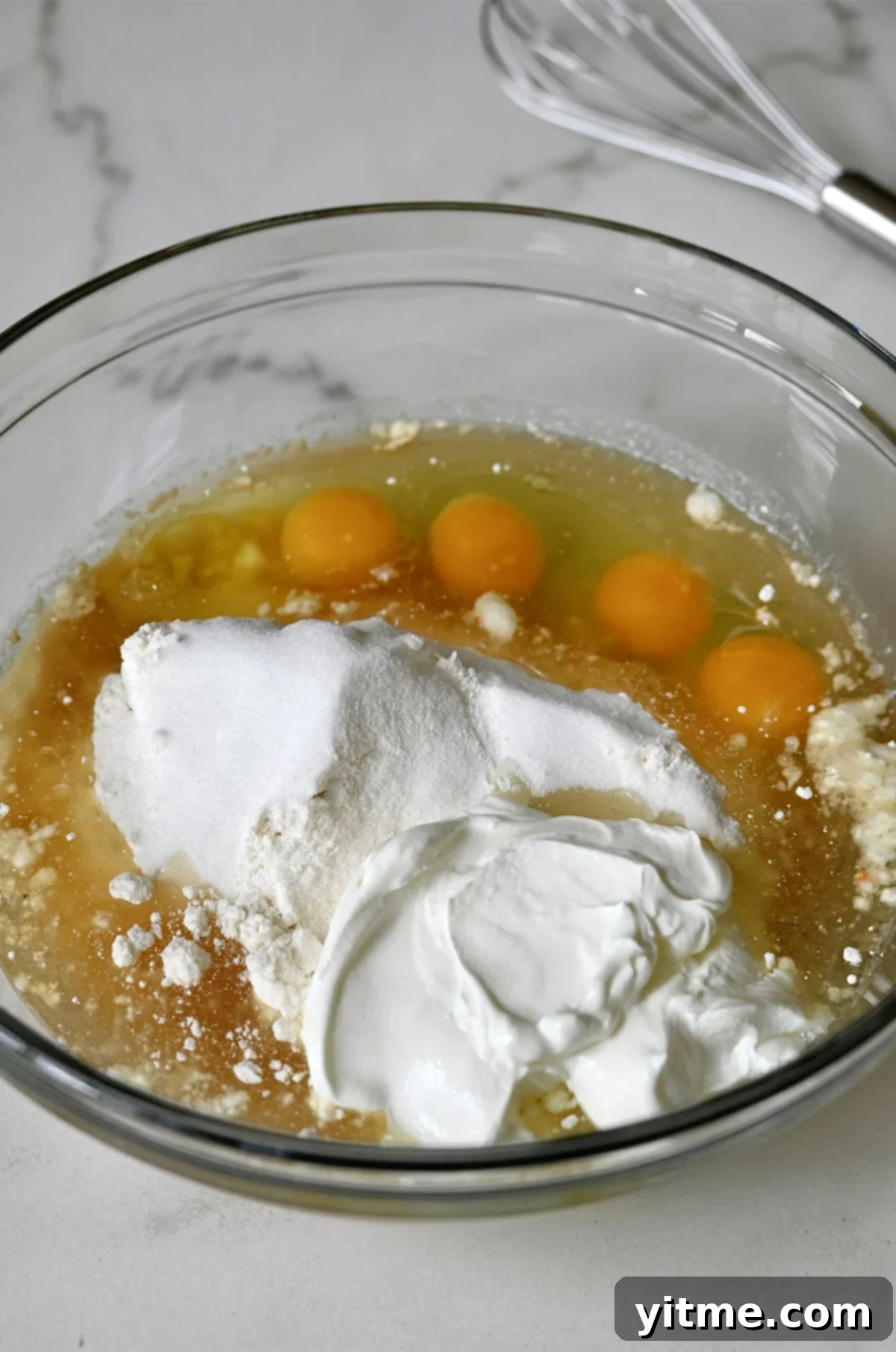 Cake mix, sour cream, eggs and vanilla extract in a bowl.