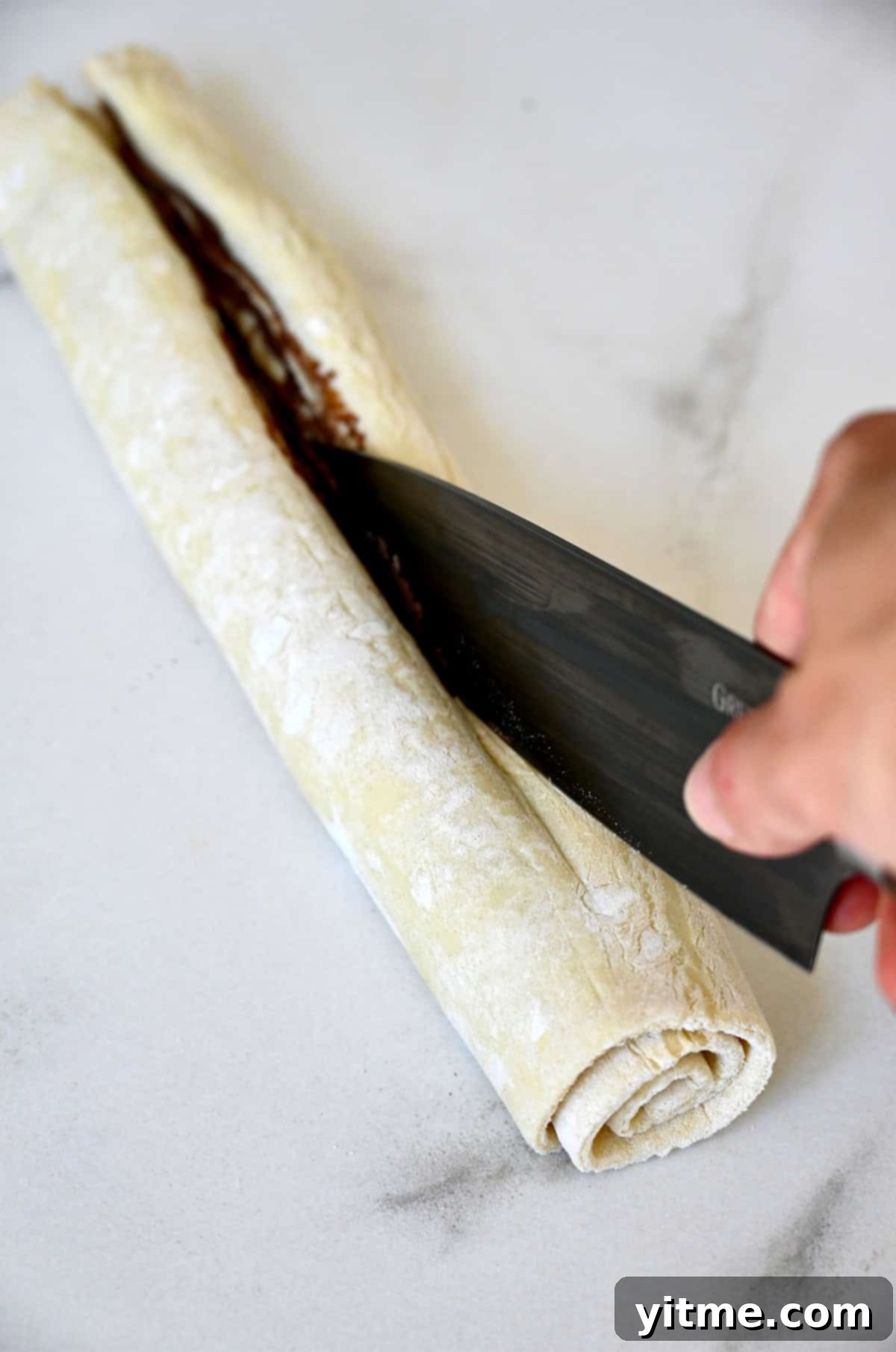 Decadent Chocolate Swirls 6 Cutting Nutella puff pastry log lengthwise.