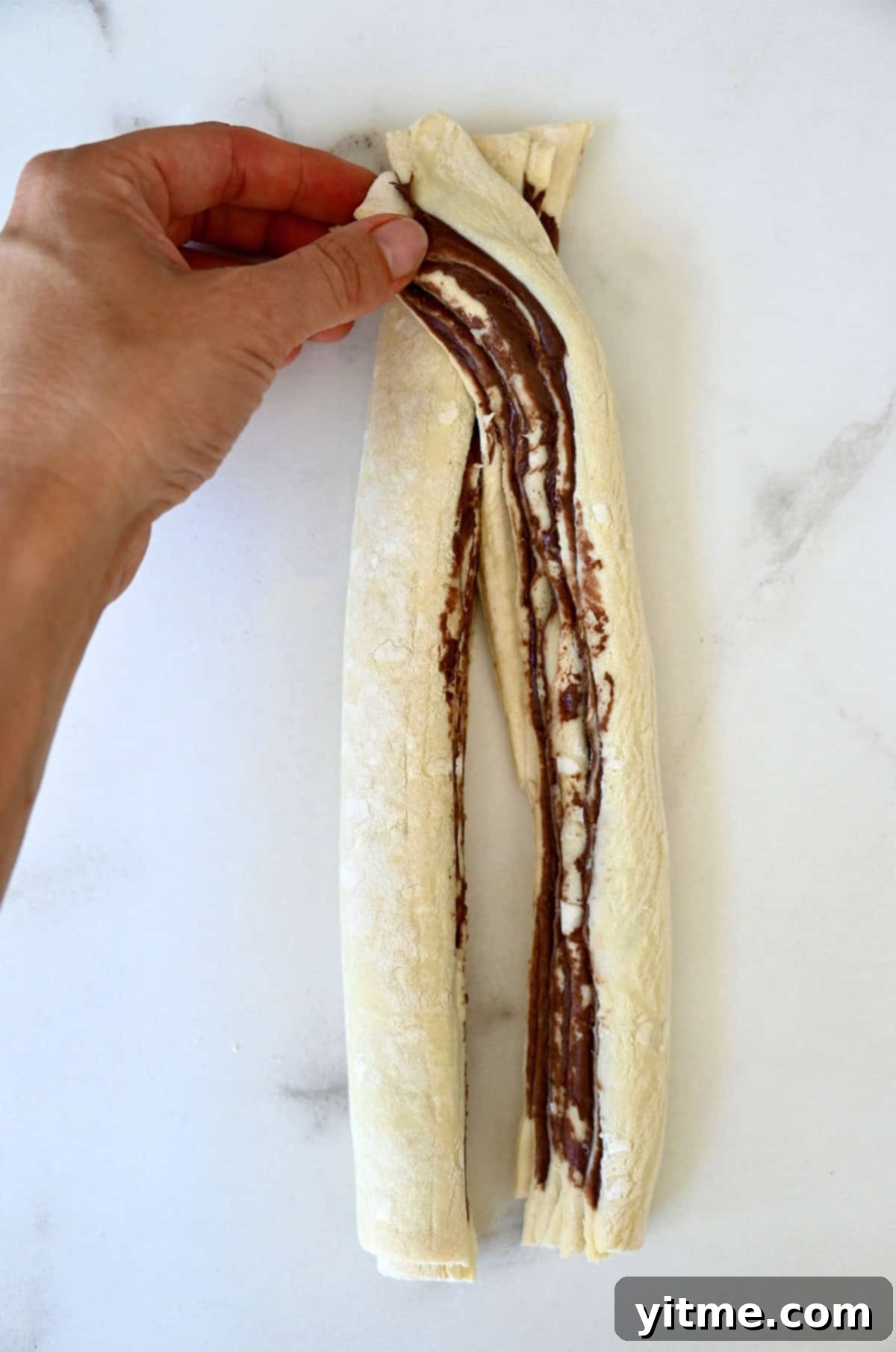 Decadent Chocolate Swirls 7 Twisting Nutella puff pastry to form a braid.