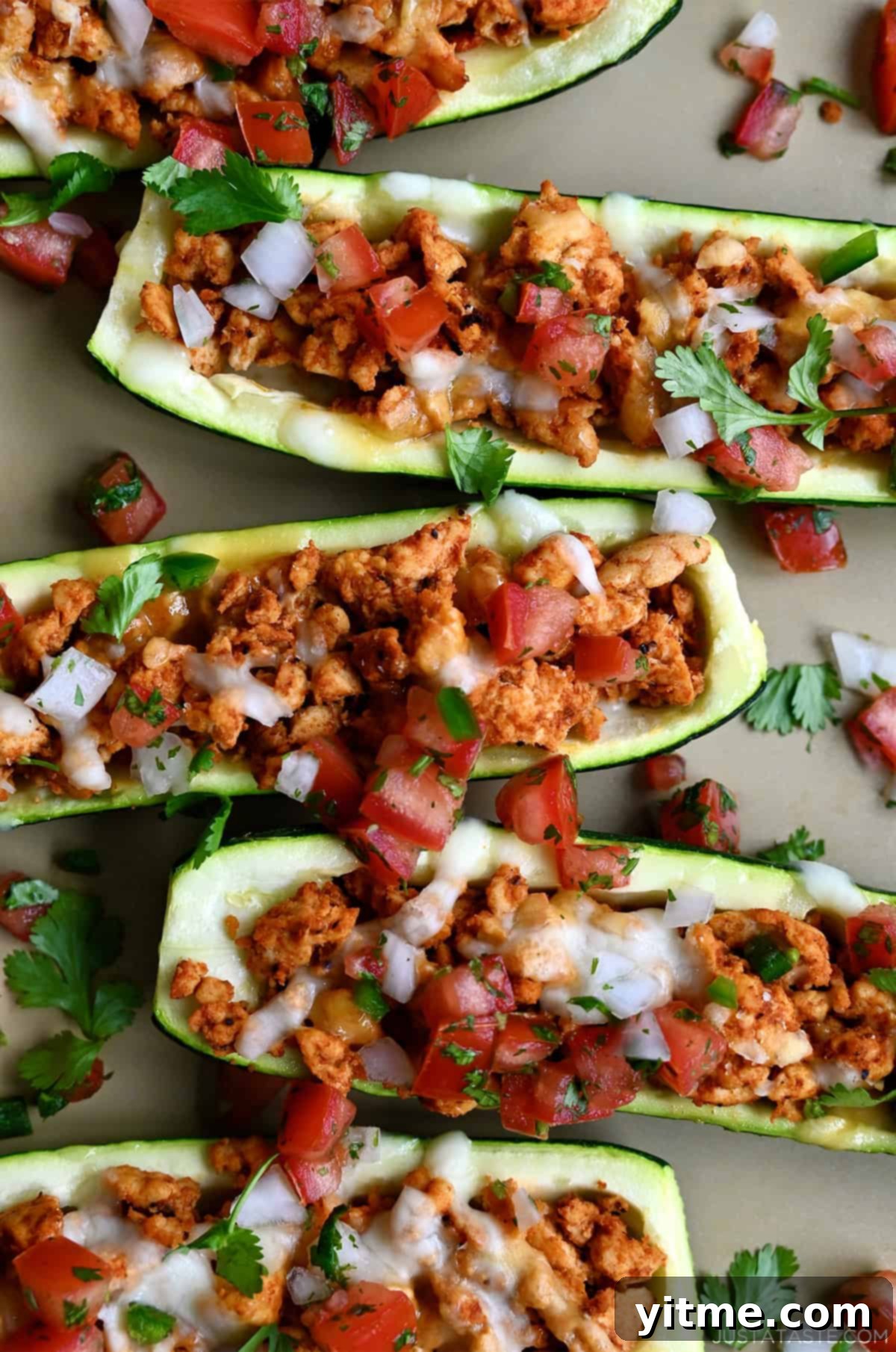 Deliciously Healthy Stuffed Zucchini Boats 8 Healthy Stuffed Zucchini Boats filled with seasoned ground turkey, topped with melted cheese, cilantro and pico de gallo.