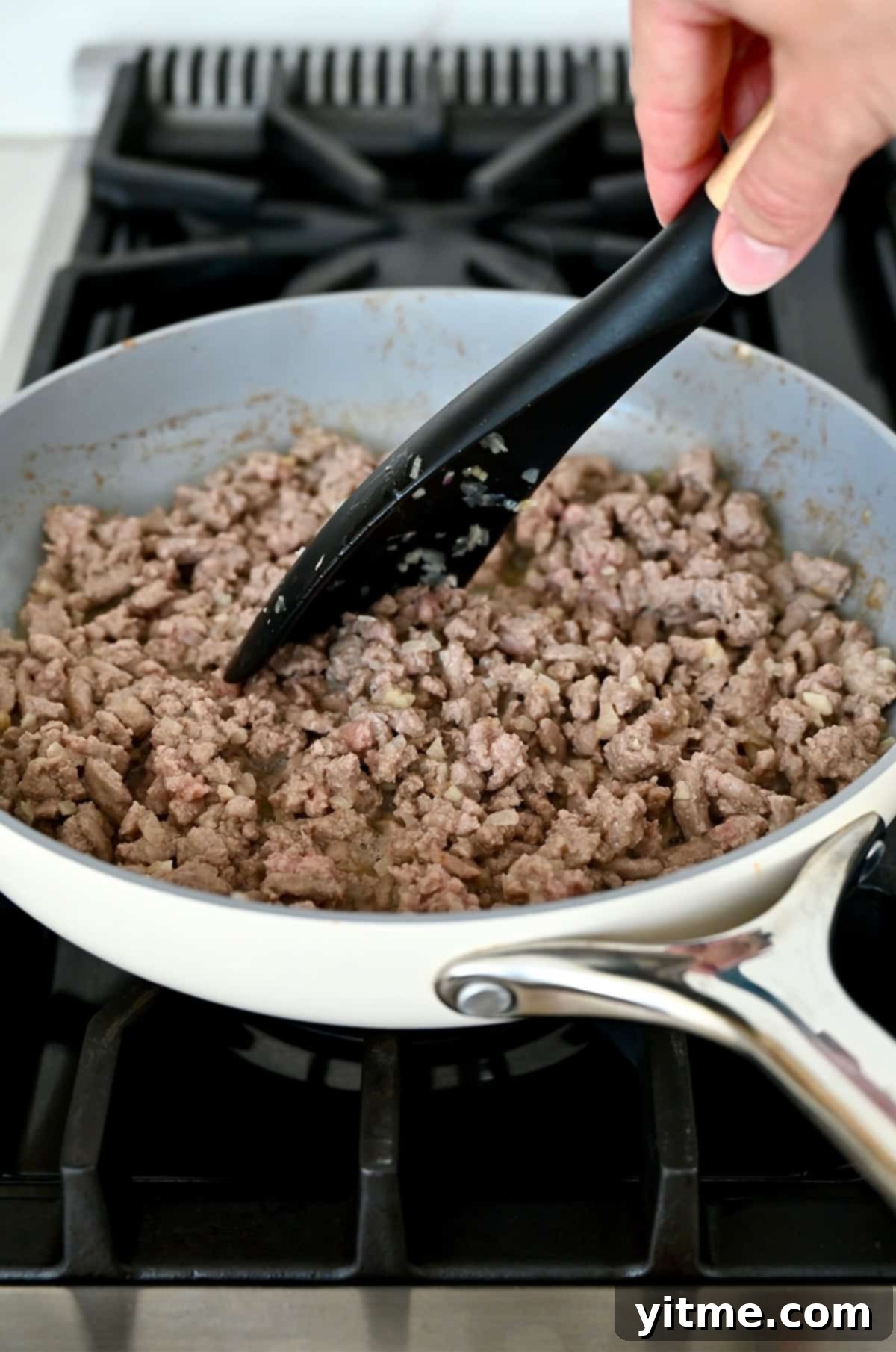 Ground chicken browning in a skillet.