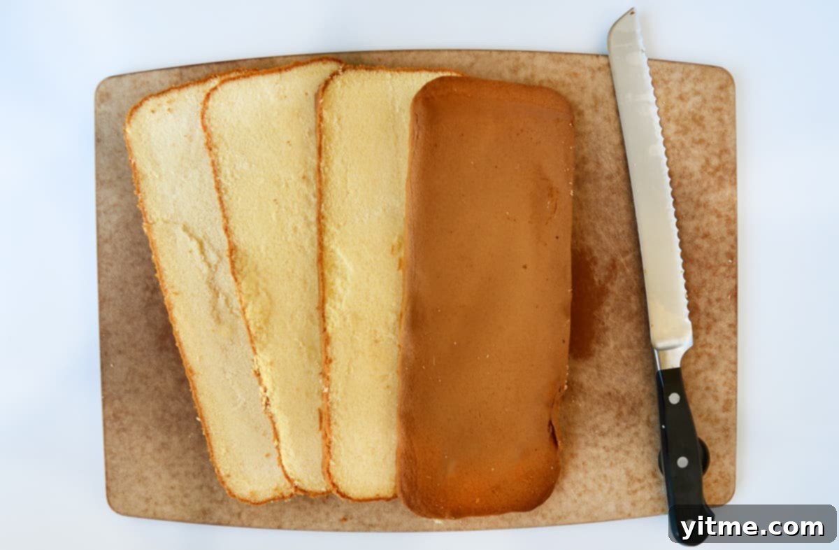 Sliced pound cake on a cutting board with a serrated knife.