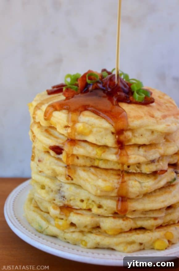 Sweet Corn Fritters with Crispy Bacon 7 Tall stack of Sweet Corn Pancakes with Bacon topped with sliced scallions and drizzled with maple syrup