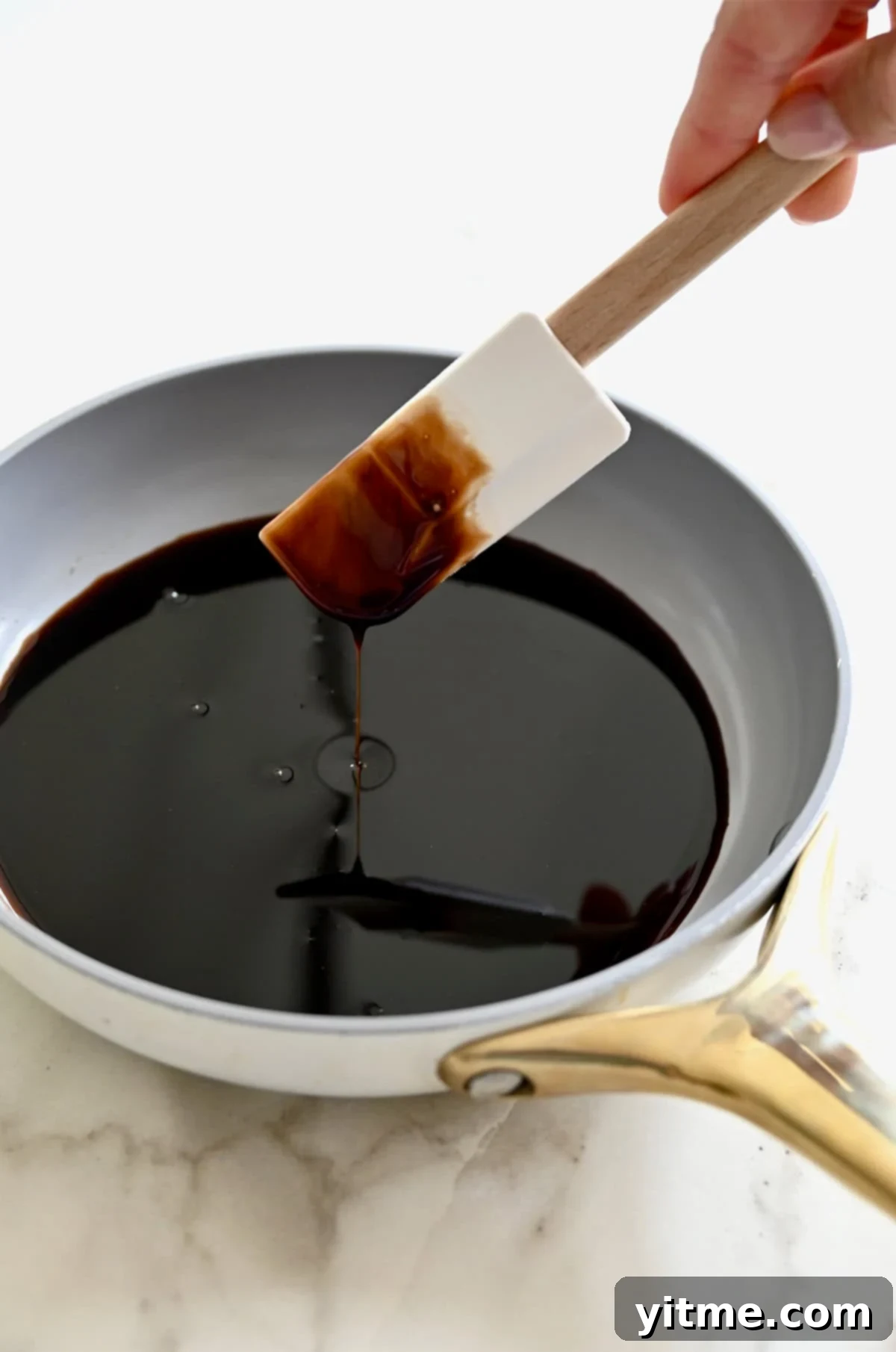 A saucepan containing homemade balsamic syrup