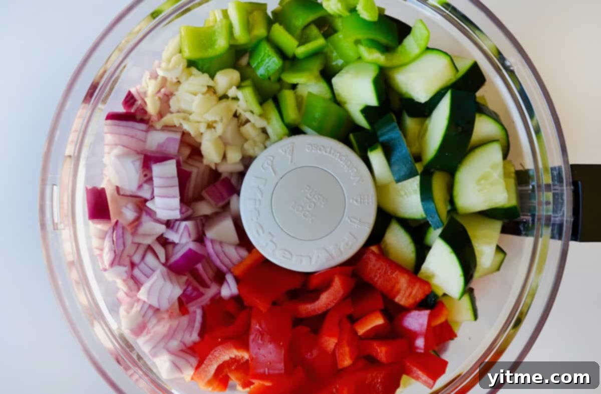 Gazpacho ingredients in a food processor bowl.