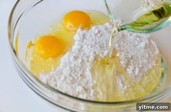 Cake mix in a glass bowl with eggs ready to be mixed