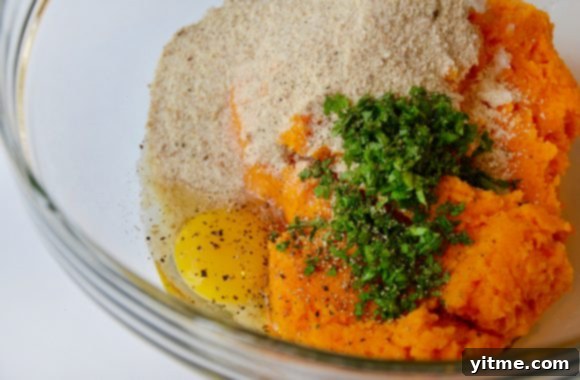 Golden Butternut Bites 5 A glass bowl containing pureed butternut squash, onions, egg, breadcrumbs and sage