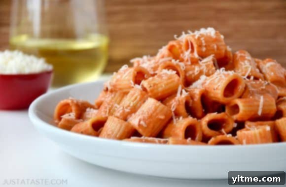 Vodka pasta on a white plate with Parmesan cheese