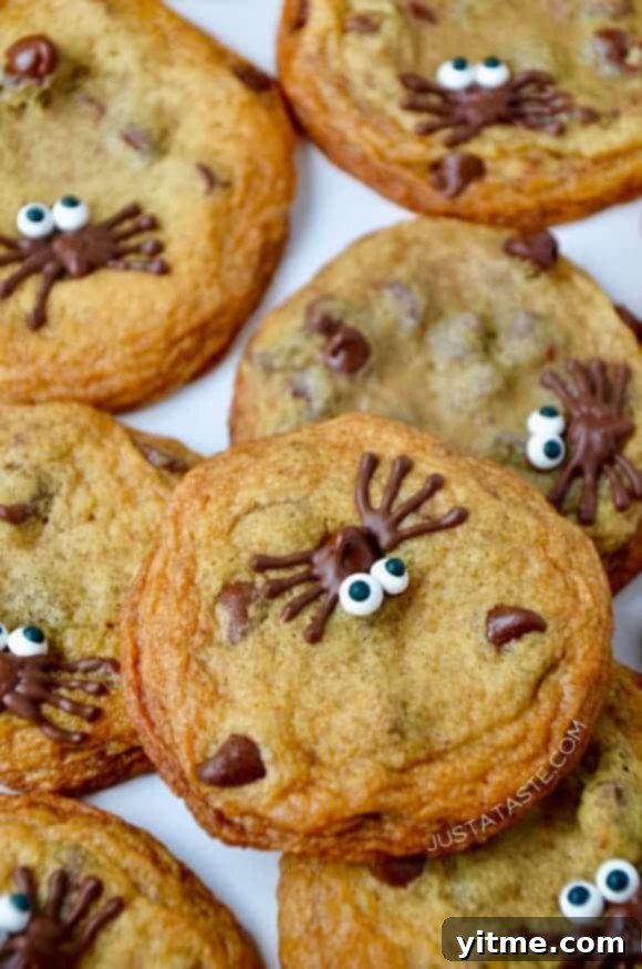 A close-up of Spider Chocolate Chip Cookies stacked on top of each other