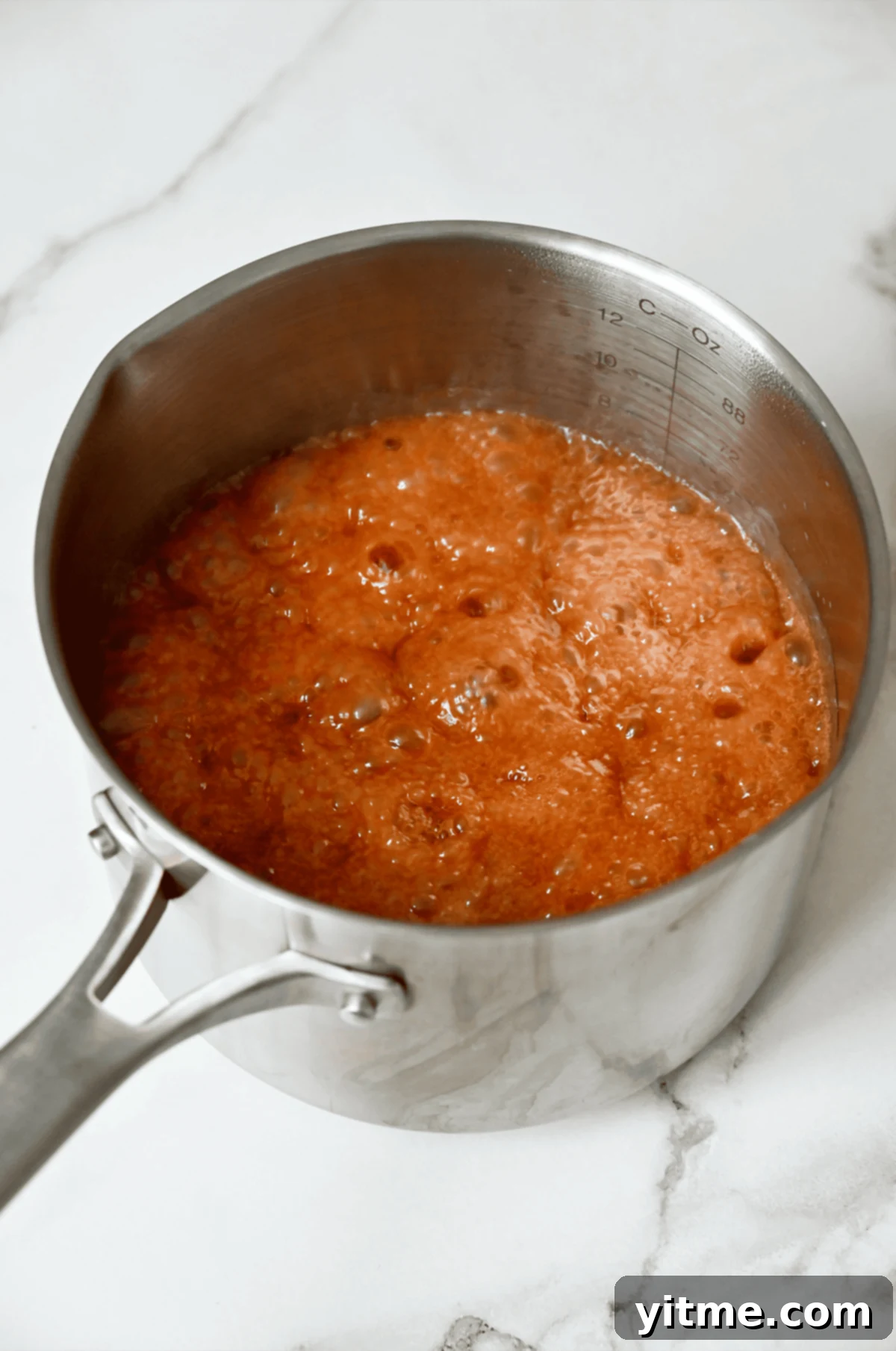 Apple Dumpling Delights: A Crescent Roll Twist 5 Caramel gently bubbling in a saucepan.