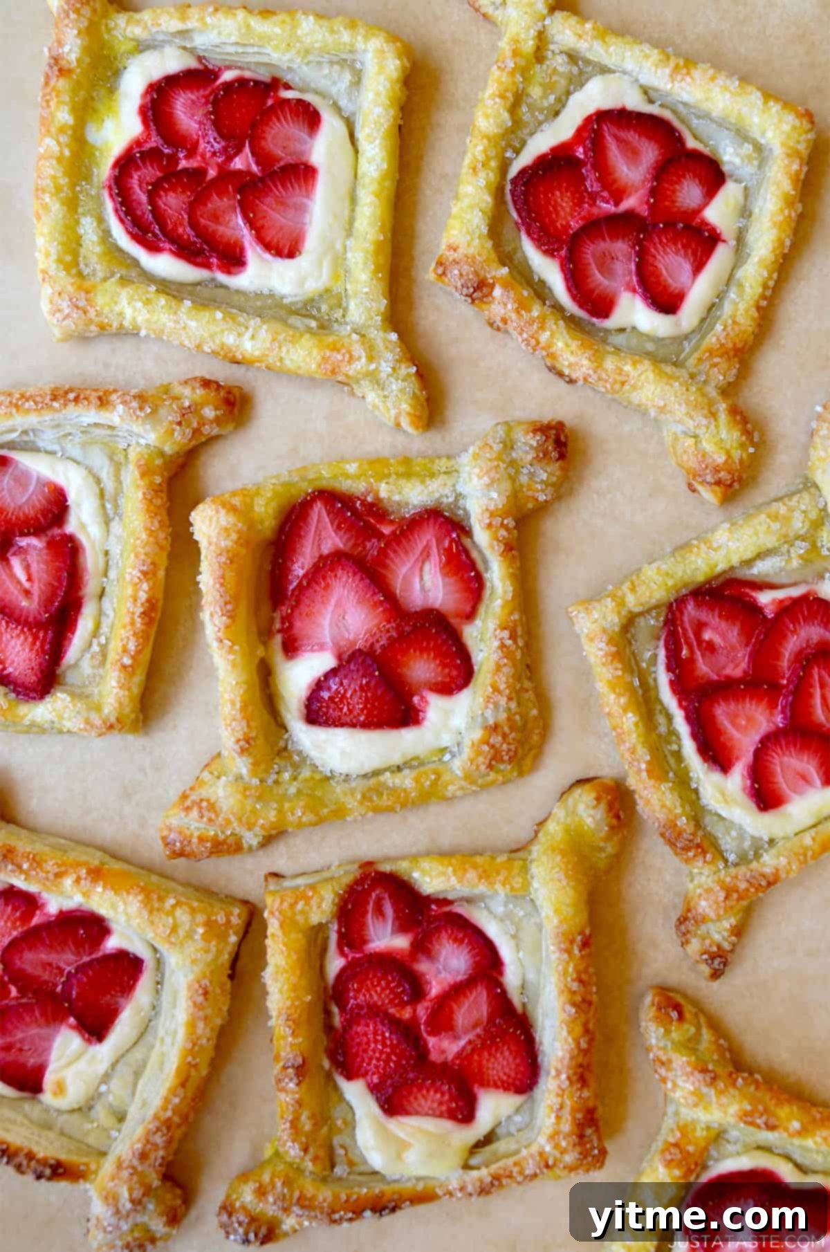 Diamond-shaped cream cheese Danish topped with fresh strawberry slices.