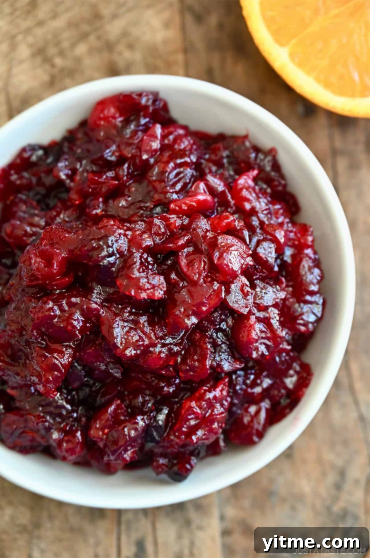 Cranberry orange sauce in a white serving bowl, ready to be served as a holiday side dish.