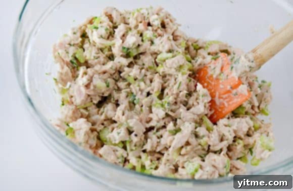 Leftover Turkey Salad with an orange spatula in a clear bowl