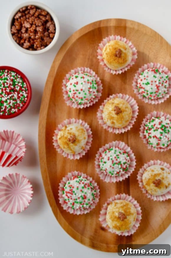 A wood plate containing gingerbread cookie balls and small bowls of sprinkles