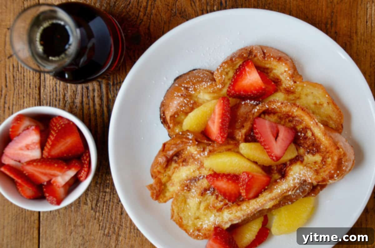 Challah French toast topped with strawberries and orange segments
