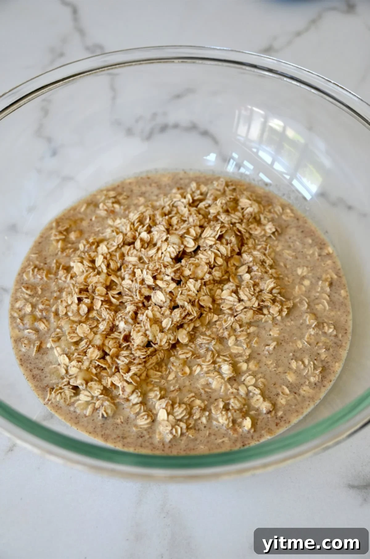 Oatmeal mixture in a glass bowl.