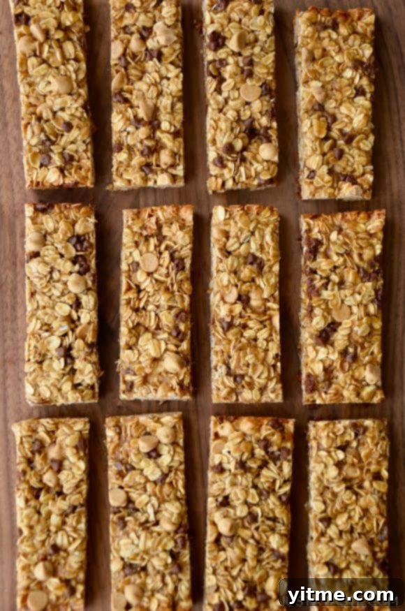 Three perfectly aligned rows of Homemade Peanut Butter Granola Bars presented on a rustic wooden background, highlighting their comforting appeal.