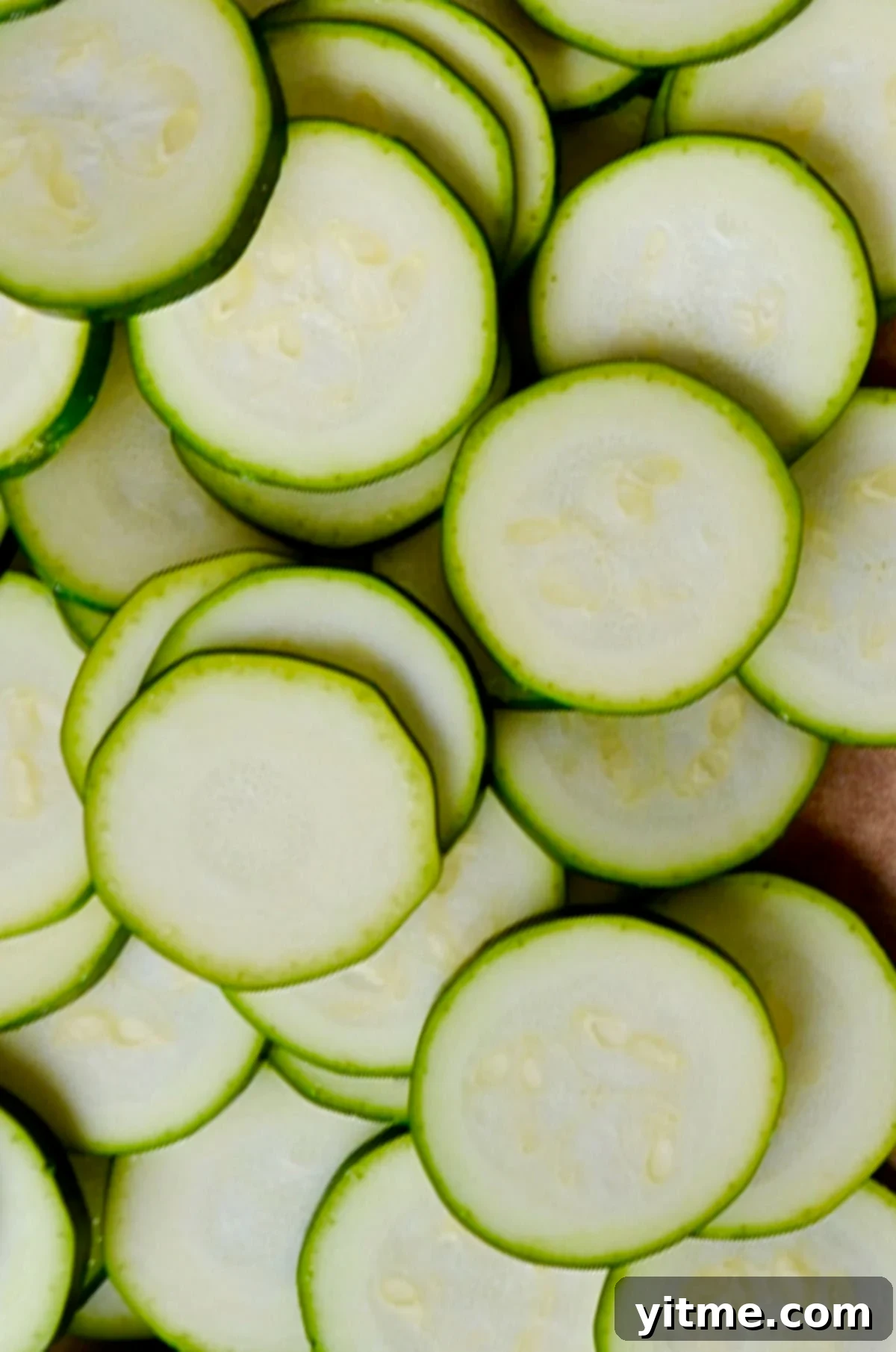 Sliced zucchini rounds on a cutting board.