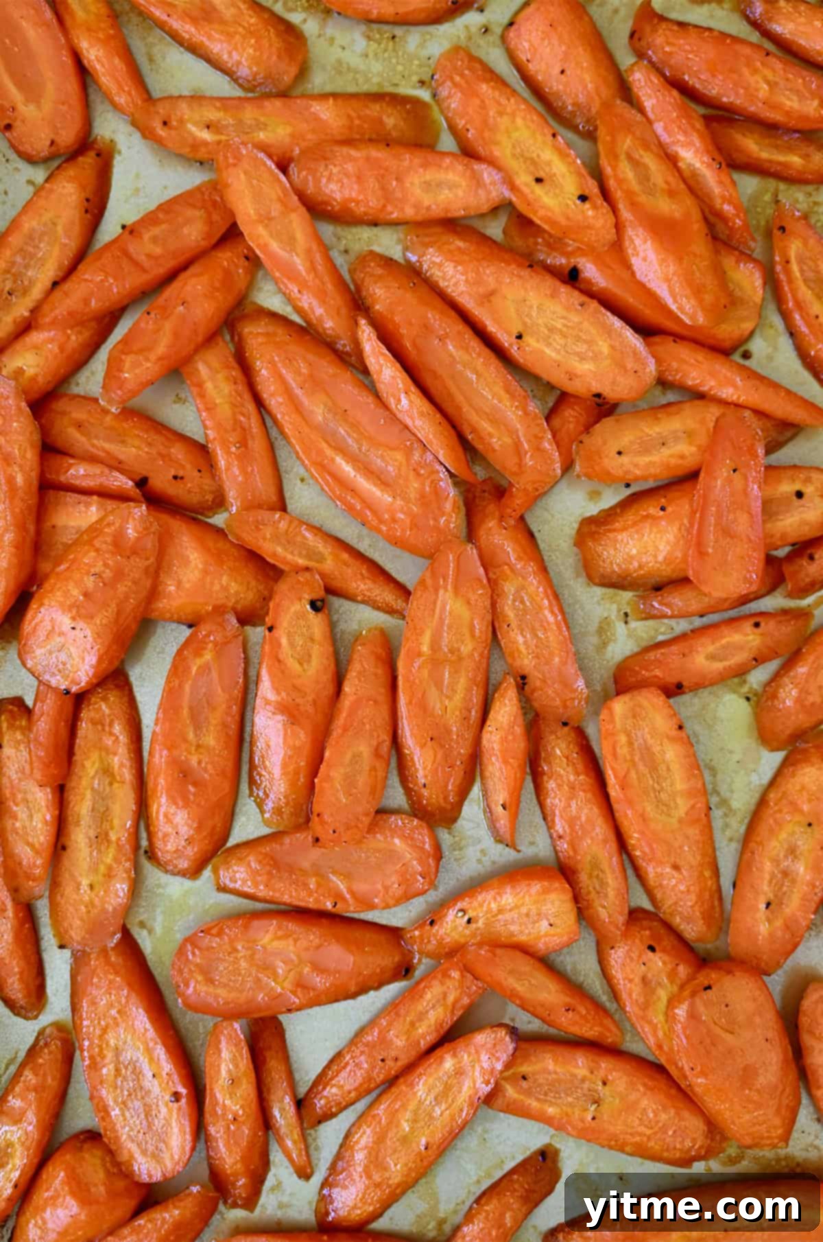 Honey-Glazed Roasted Carrots 7 Honey glazed roasted carrots on a baking sheet.