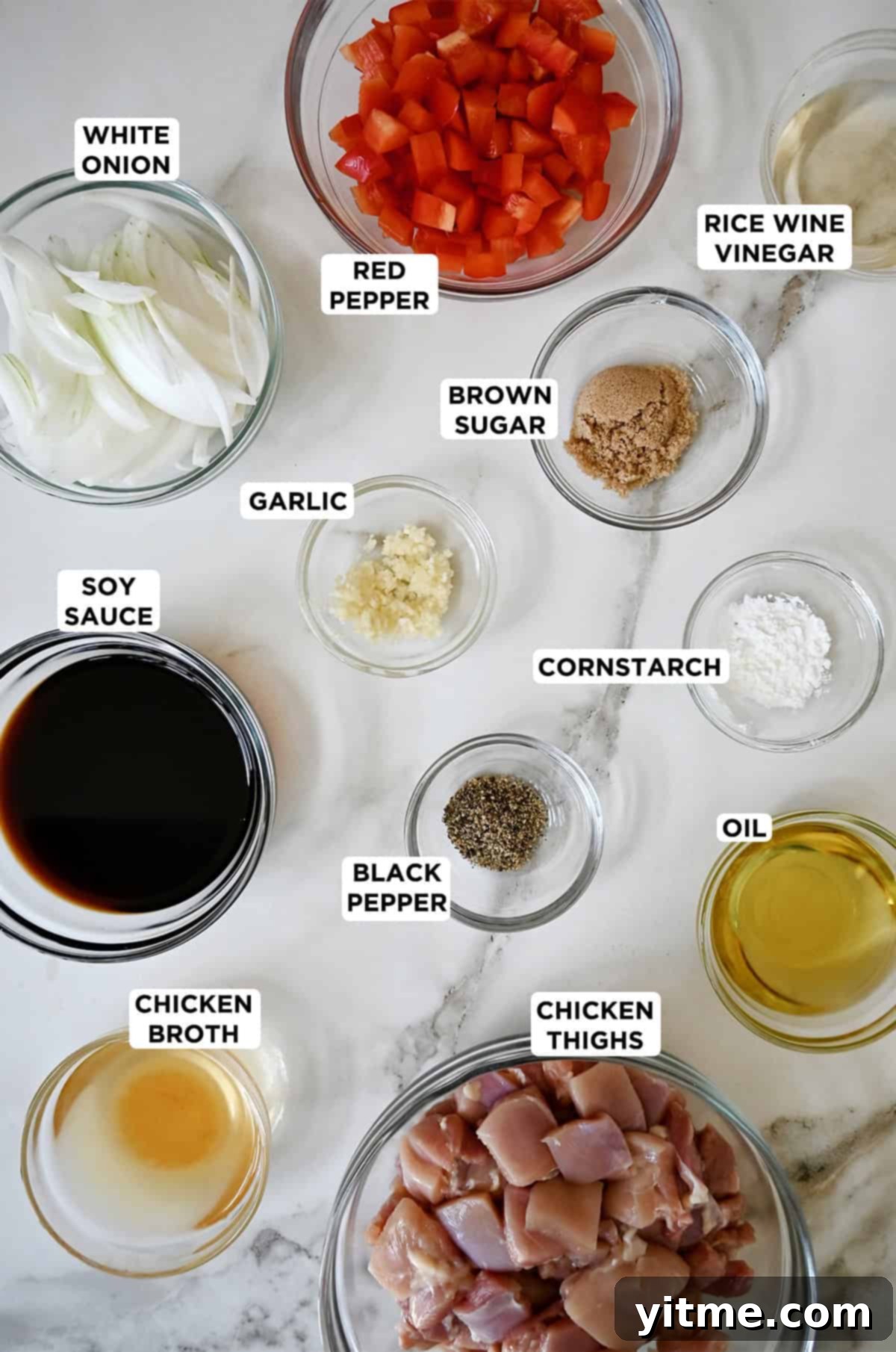 Ingredients for black pepper chicken in glass bowls.