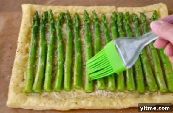 Brushing Olive Oil on Cheesy Asparagus Tart
