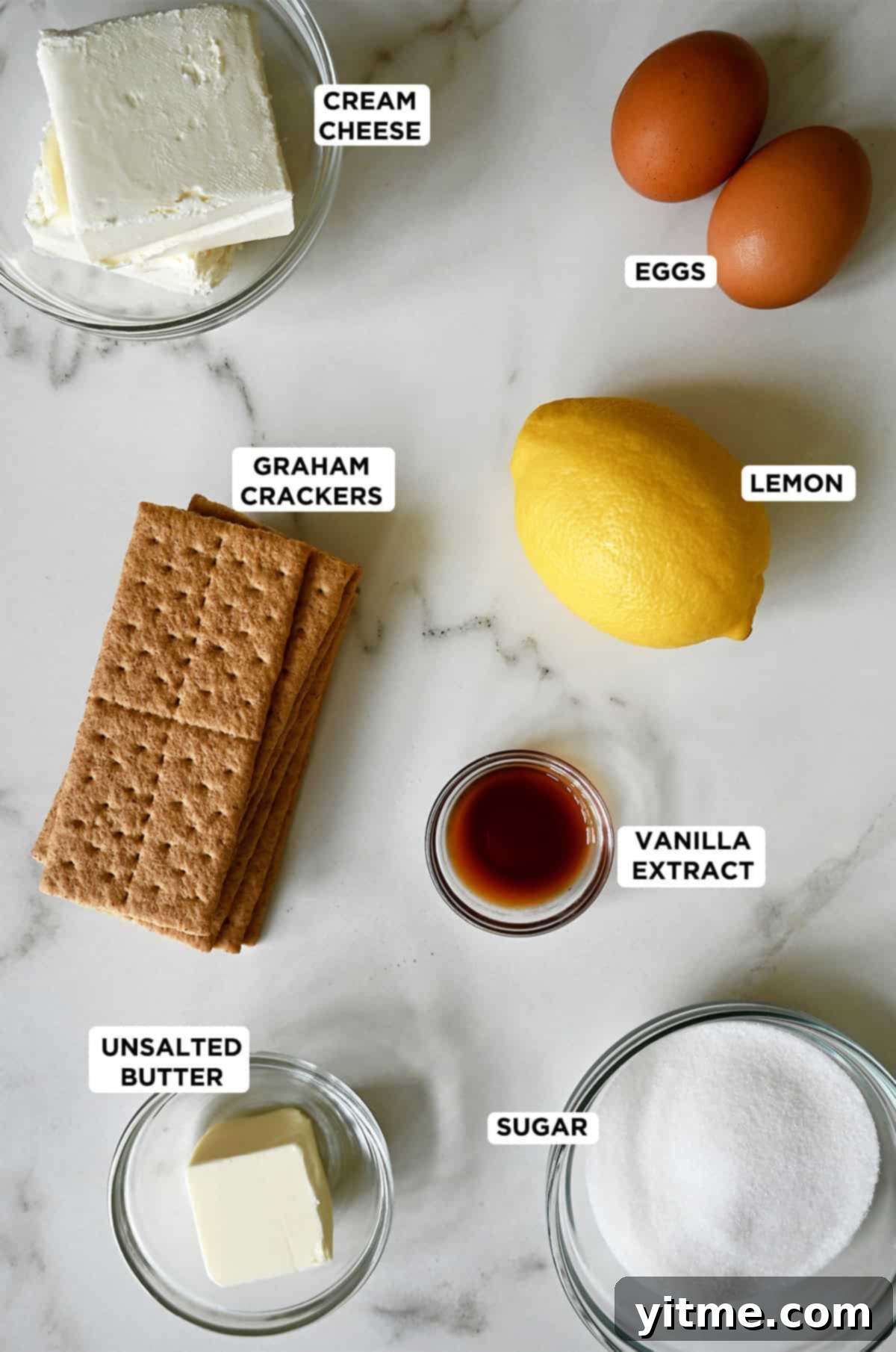 Cheesecake bar ingredients: Cream cheese, eggs, sugar, butter, vanilla extract, lemon and graham crackers.