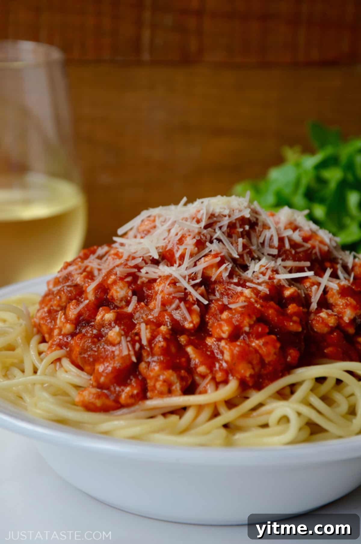Spaghetti topped with turkey bolognese and cheese