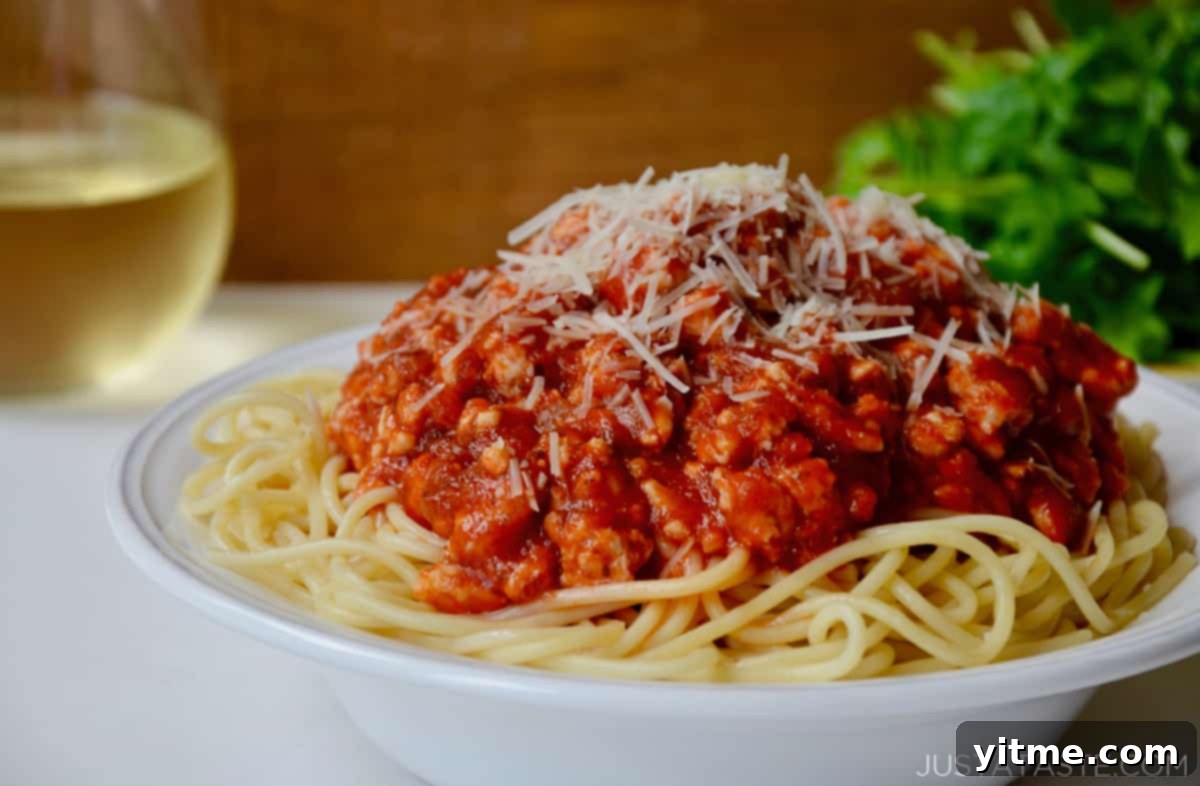 Turkey bolognese served with wine and salad