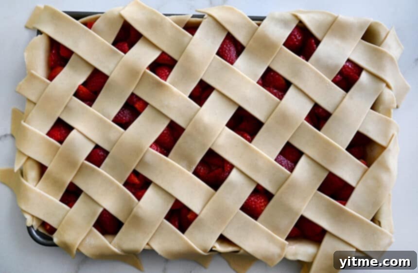 A top-down view of an unbaked slab pie