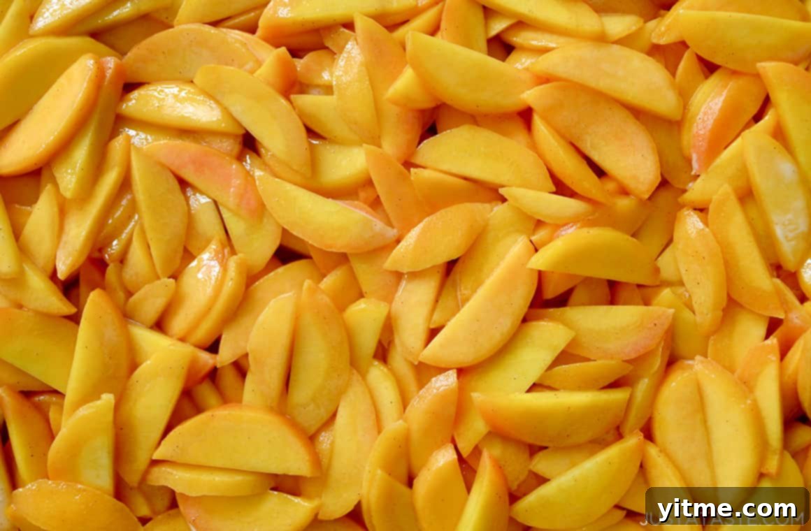 Close-up shot of sliced peaches tossed with brown sugar and cinnamon