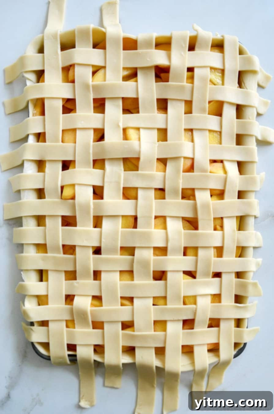 A beautiful lattice pie crust on top of a peach slab pie