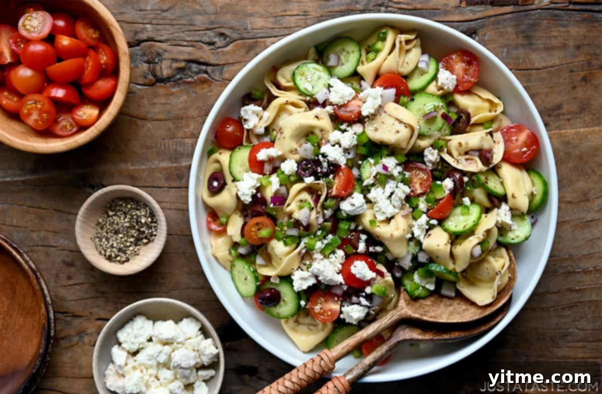 Greek Tortellini Pasta Salad with serving spoons