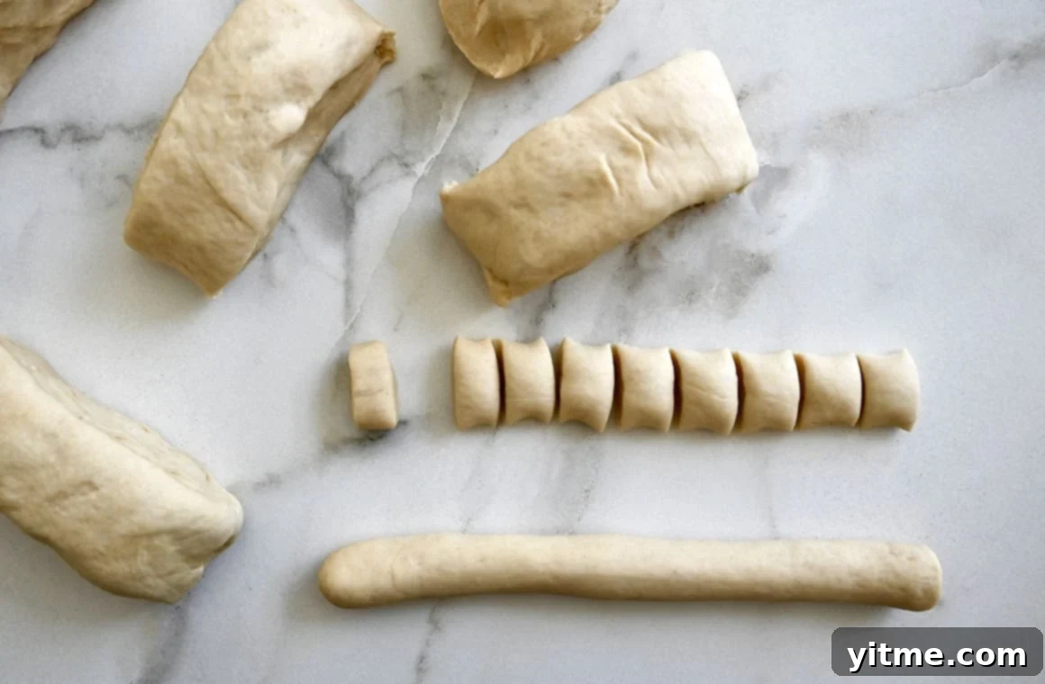 A top-down view of rolled dough next to more dough cut into small pieces