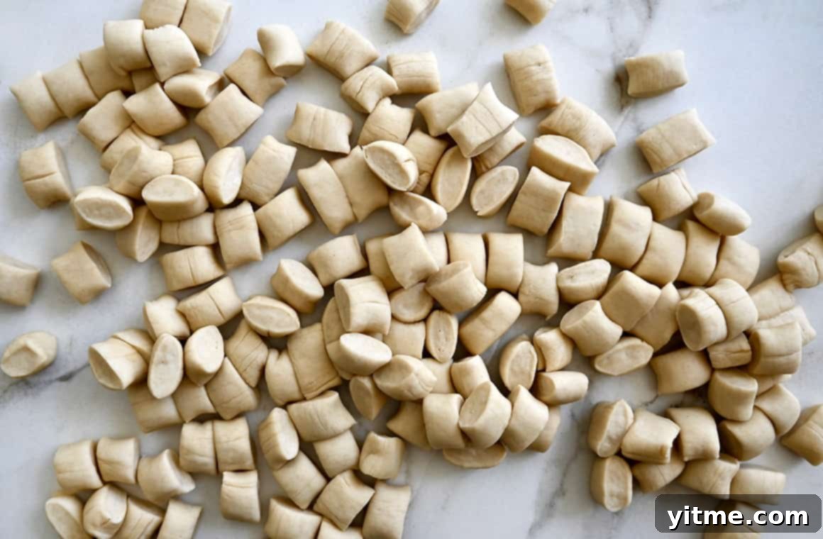 A top-down view of unbaked pieces of pretzel dough