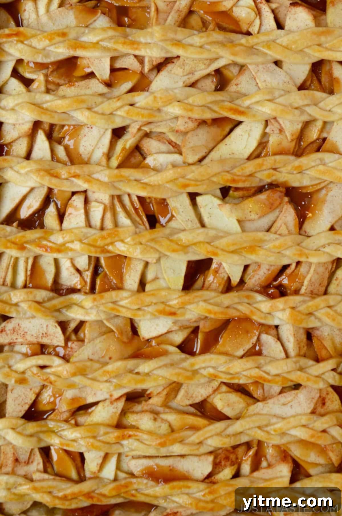 A sheet pan with the finished golden brown caramel apple slab pie.
