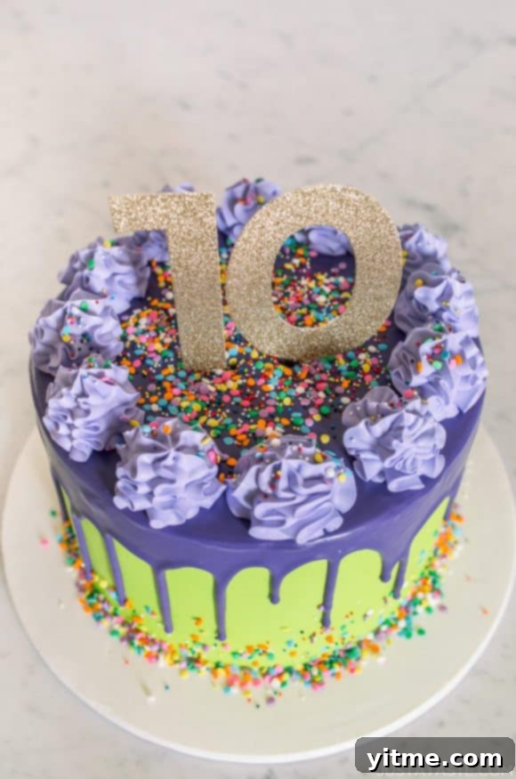 A delectable purple and green 10-year anniversary cake, complete with tempting drips and sprinkles. A delicious symbol of a decade of culinary success for Just a Taste.
