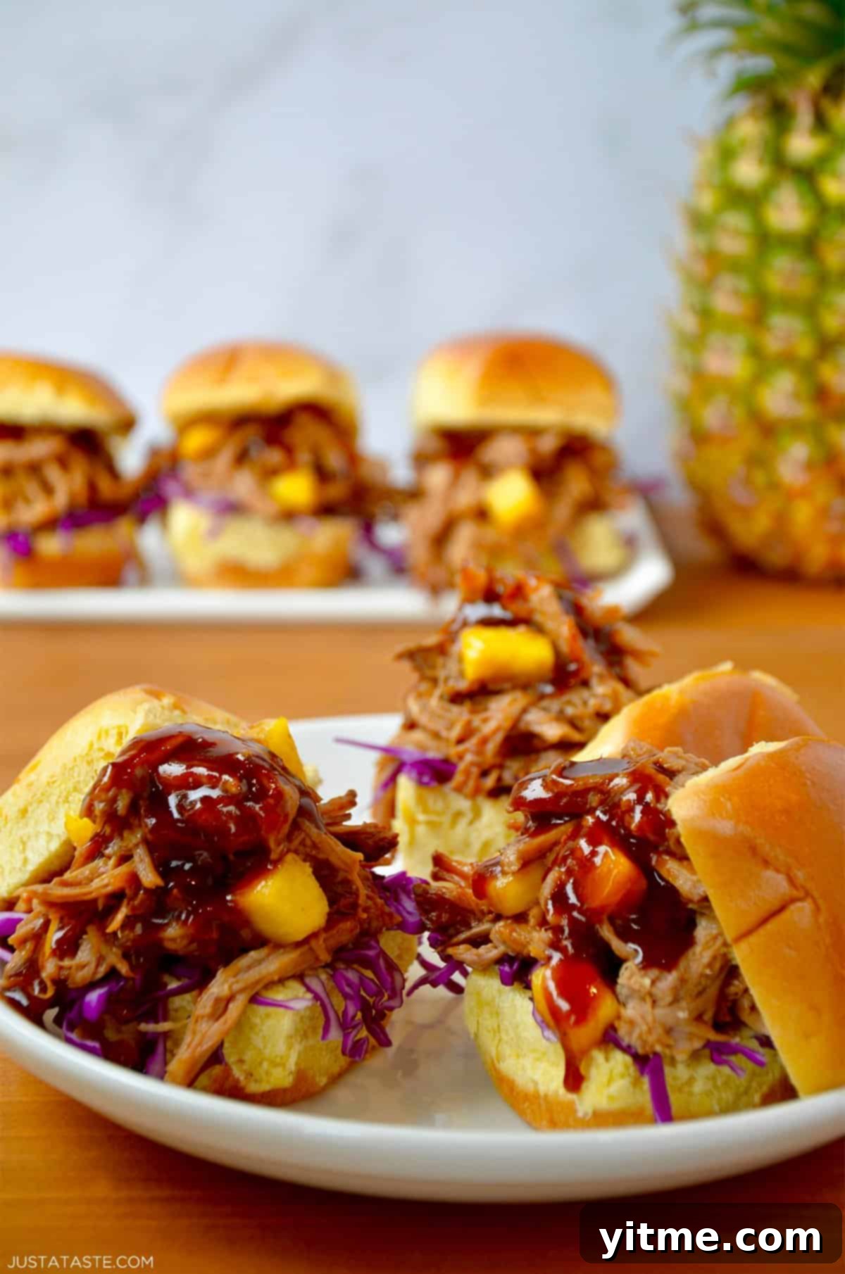 Slow cooker Hawaiian pulled pork with pineapple chunks and barbecue sauce on slider buns