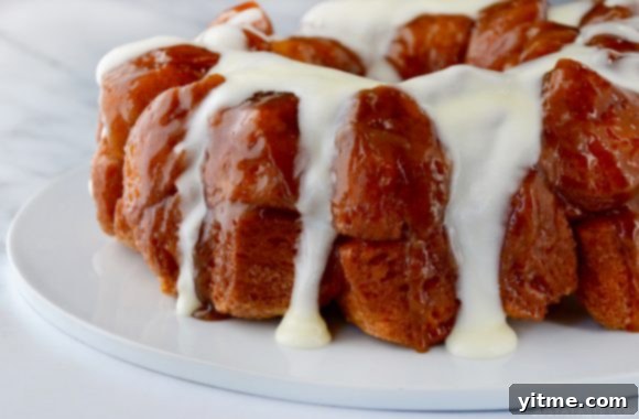 Monkey Bread with Cream Cheese Glaze on white serving plate