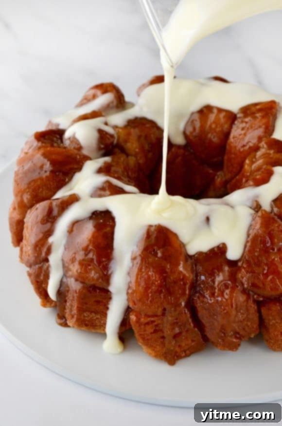 Monkey Bread with Cream Cheese Glaze being poured over top