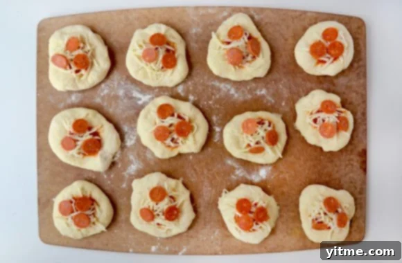 Step-by-step: Making pizza pockets filled with shredded mozzarella cheese and pepperoni