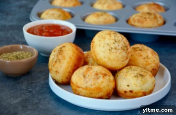 Delicious Homemade Muffin Tin Pizza Pockets served with a side of warm marinara sauce