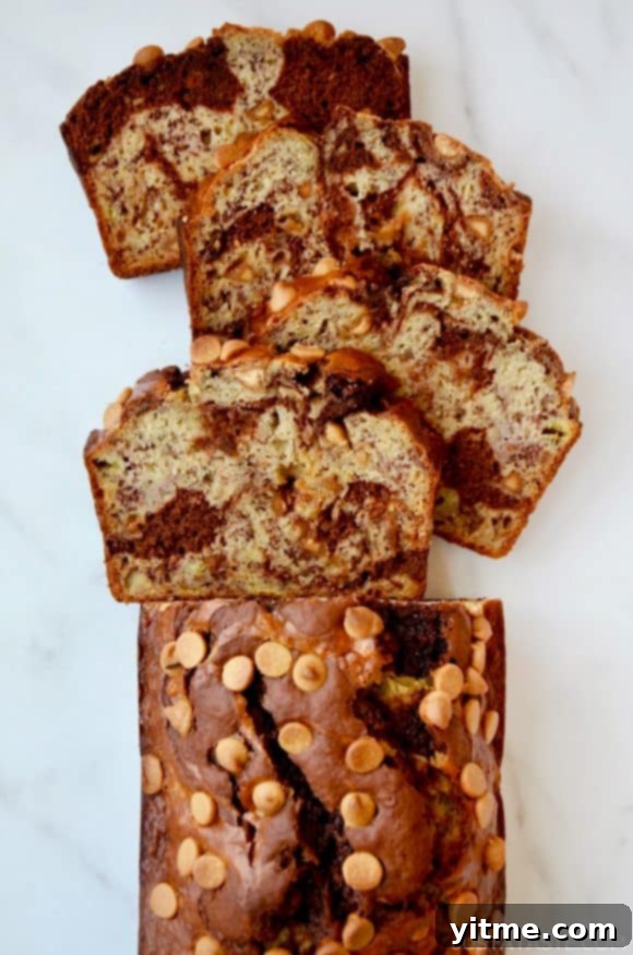 A top down view of a loaf of Chocolate Peanut Butter Banana Bread cut into slices