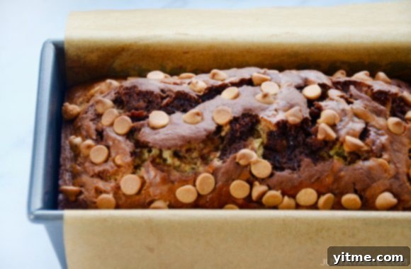 Parchment paper-lined bread pan with the best chocolate peanut butter banana bread
