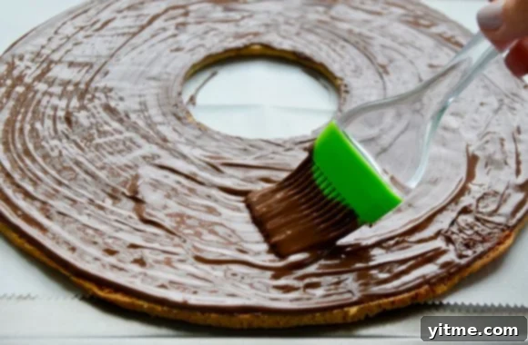 Samoa Dream Cake 7 Brushing cookie cake with melted chocolate