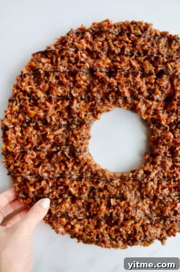 Samoa Dream Cake 10 A top down view of a Giant Samoas Cookie Cake with a female hand touching it