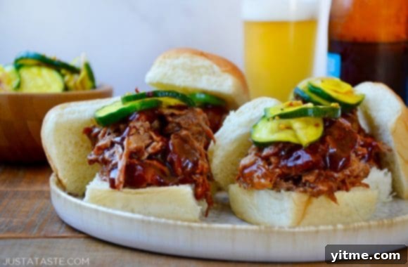 Fork-Tender Instant Pot BBQ Pulled Pork 5 Instant Pot Barbecue Pulled Pork and pickles piled atop buttery buns