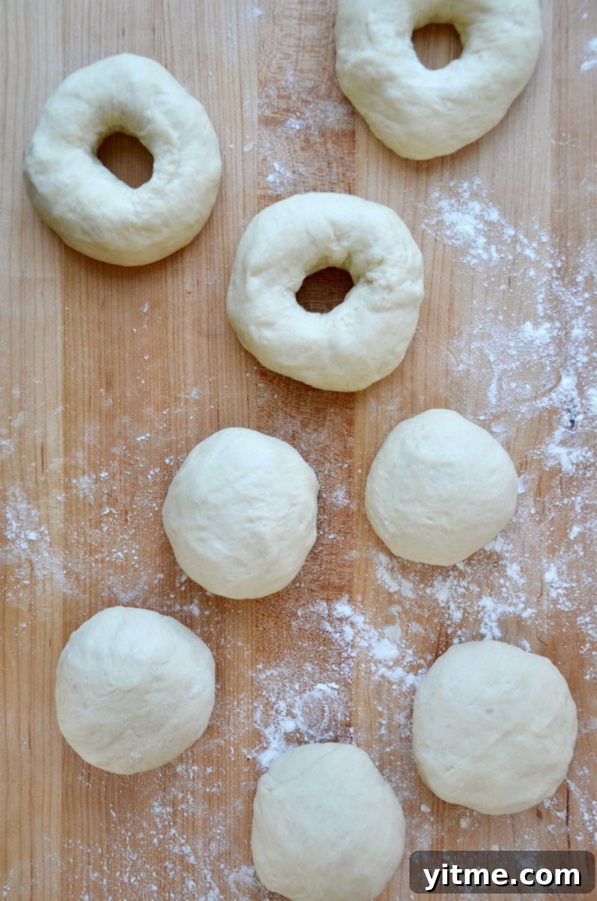 Shaping dough into bagels.