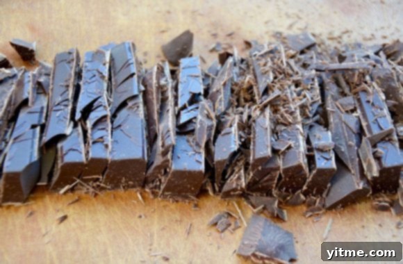 Chopped semisweet chocolate on wood cutting board